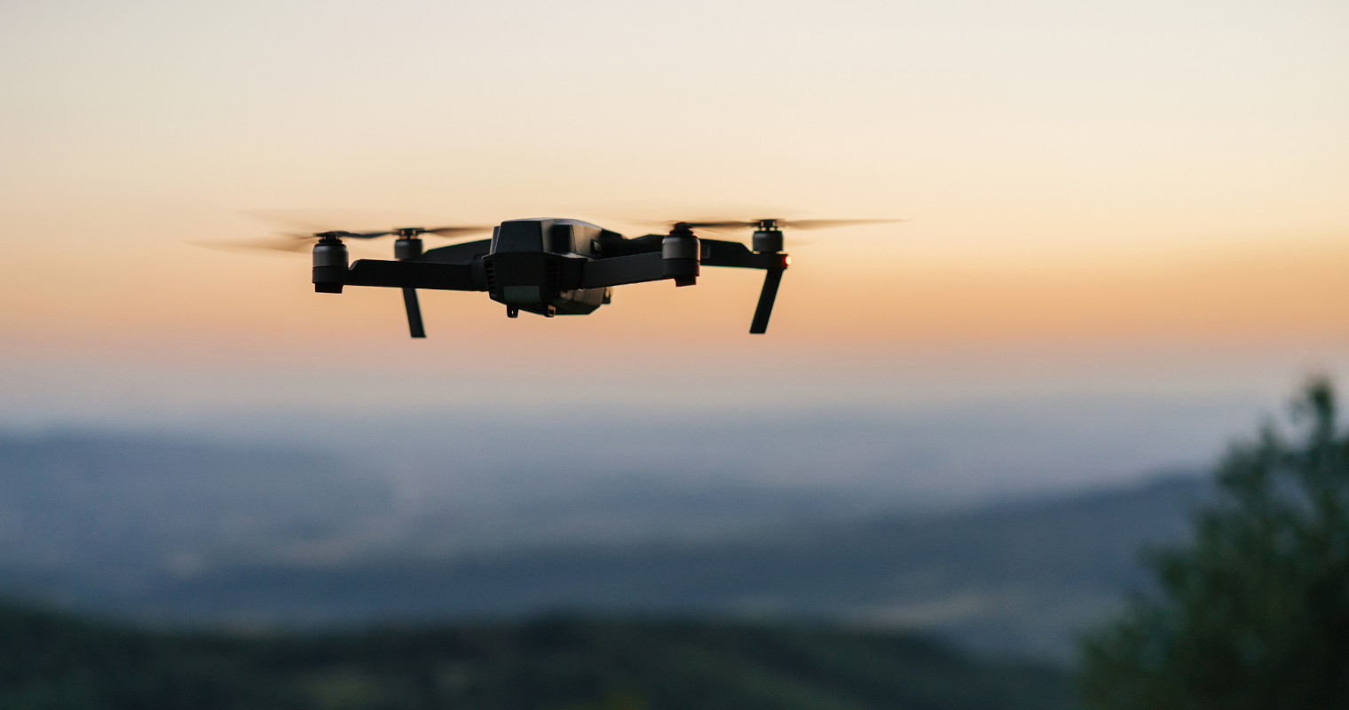 Drone flying over a mountain landscape at dusk