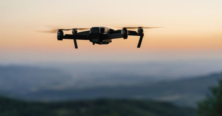 Drone flying over a mountain landscape at dusk
