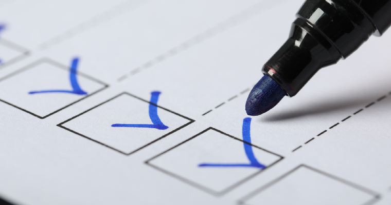 Marker ticking boxes on a compliance checklist